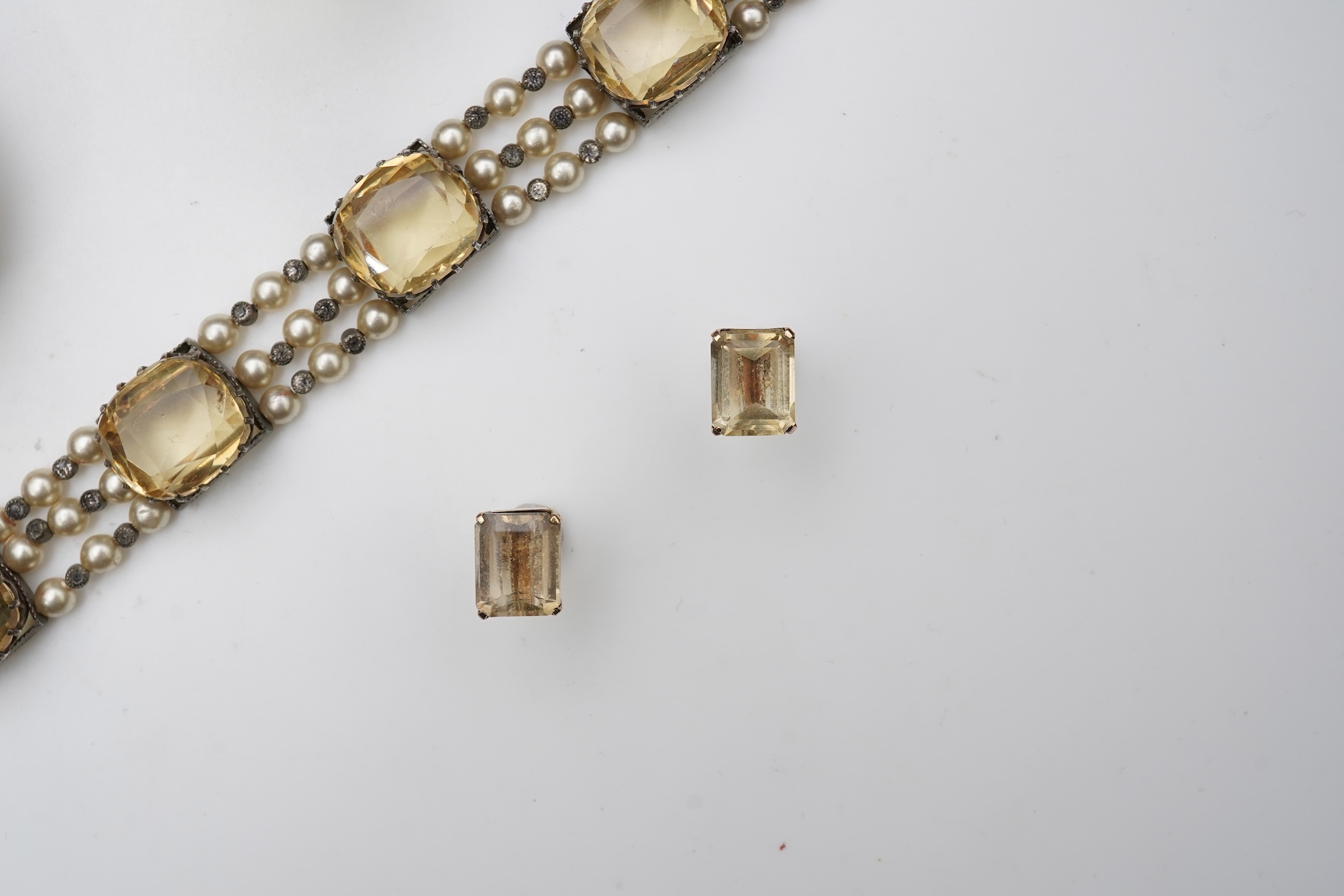 A collection of citrine jewels and a paste bracelet